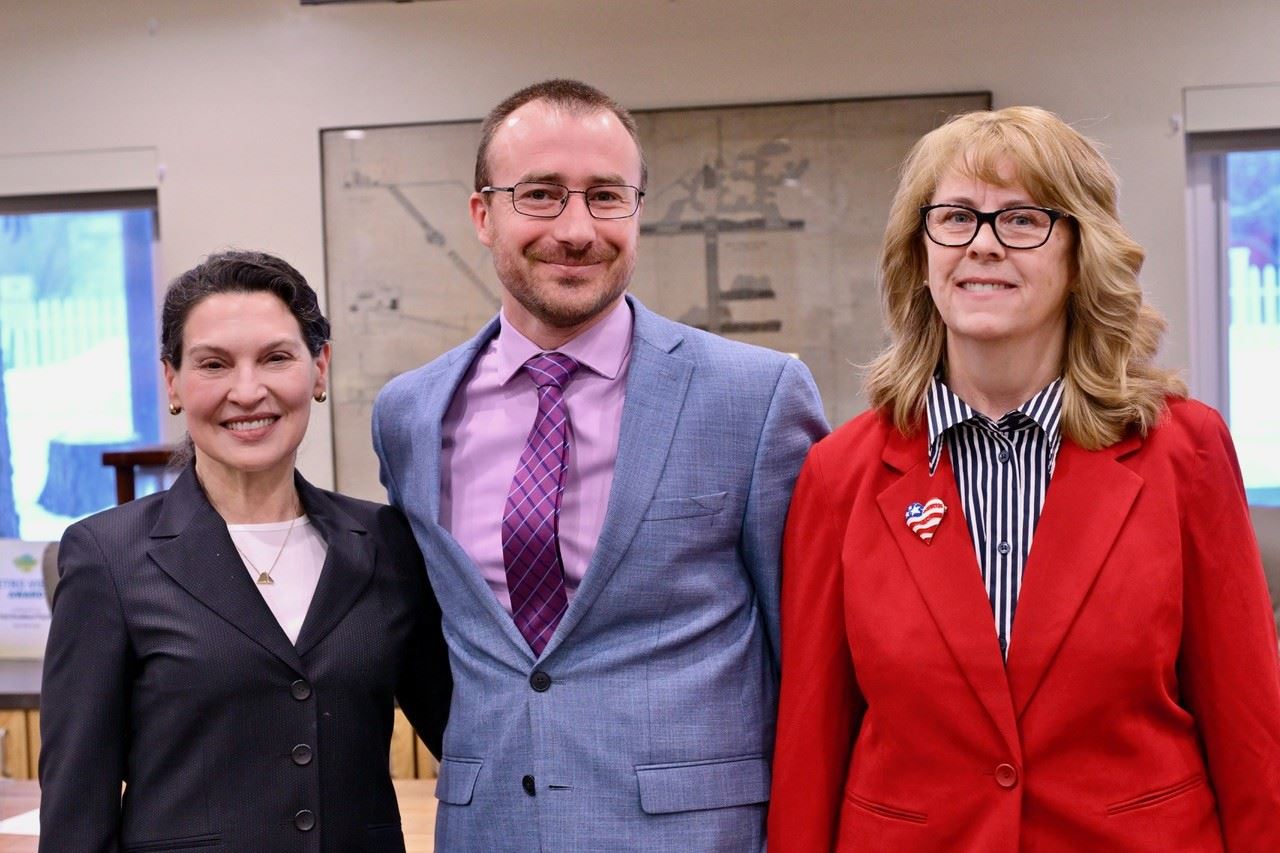 Commissioners Lloyd, Marlin, and Hartman-Ball pose for a photo in the BOCC room after being sworn in
