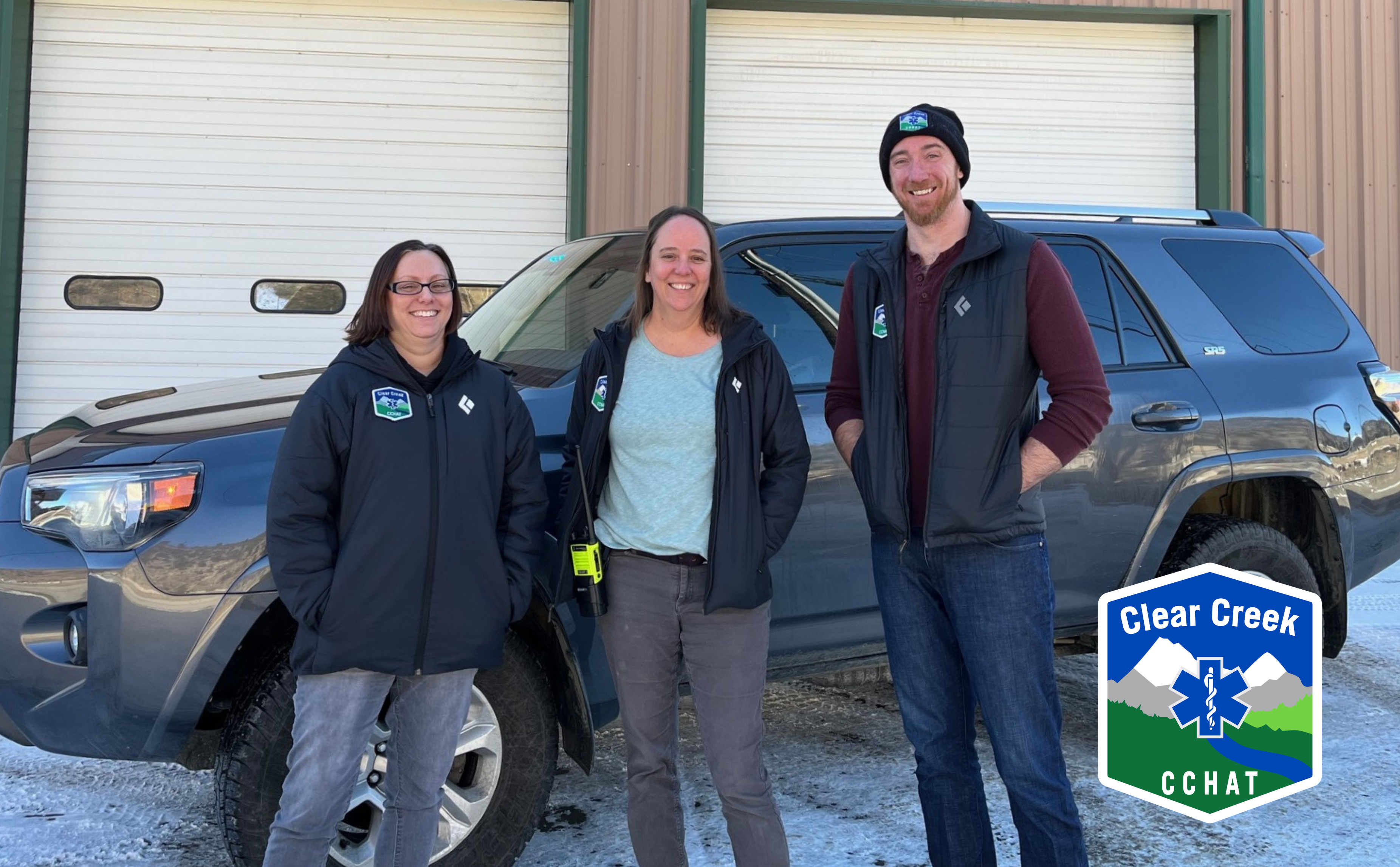 A photo with three members of the Clear Creek Health Assistance Team in front of the CCEMS car.